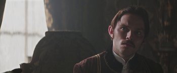 Movie still from “The Current War: Director's Cut” (2017), directed by Alfonso Gomez-Rejon – A person wearing a suit and tie; Close Up shot, Over the shoulder angle