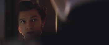 Movie still from “The Current War: Director's Cut” (2017), directed by Alfonso Gomez-Rejon – A man with a curly hair is looking at the camera; Close Up shot, Over the shoulder angle