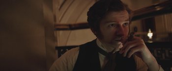 Movie still from “The Current War: Director's Cut” (2017), directed by Alfonso Gomez-Rejon – A man wearing a vest and a neck tie; Close Up shot, Over the shoulder angle