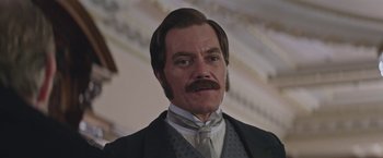 Movie still from “The Current War: Director's Cut” (2017), directed by Alfonso Gomez-Rejon – A person wearing a suit and tie; Close Up shot, Low angle