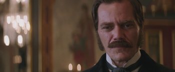 Movie still from “The Current War: Director's Cut” (2017), directed by Alfonso Gomez-Rejon – A person wearing a suit and tie; Close Up shot, Over the shoulder angle