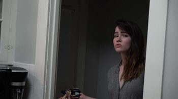 Movie still from “The Curse of Professor Zardonicus” (2022), directed by Gabriel Theis – A woman taking a picture of herself in the mirror; Close Up shot, Low angle