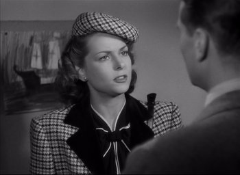 Movie still from “The Curse of the Cat People” (1944), directed by Robert Wise – A black and white photo of a woman wearing a hat; Close Up shot, Over the shoulder angle