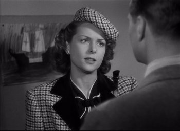 Movie still from “The Curse of the Cat People” (1944), directed by Robert Wise – A black and white photo of a woman wearing a hat; Close Up shot, Over the shoulder angle