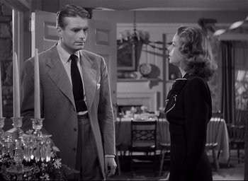 Movie still from “The Curse of the Cat People” (1944), directed by Robert Wise – A man and a woman standing next to each other in a room; Medium shot, Low angle