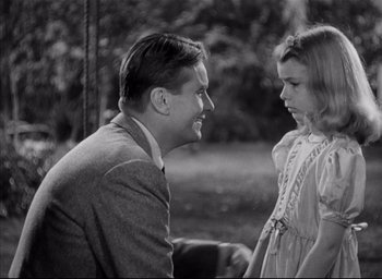 Movie still from “The Curse of the Cat People” (1944), directed by Robert Wise – A man and a little girl talking to each other; Medium shot, Over the shoulder angle