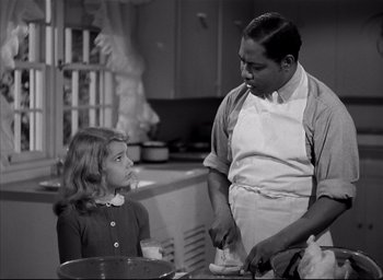 Movie still from “The Curse of the Cat People” (1944), directed by Robert Wise – A man and a little girl in a kitchen; Medium shot, High angle