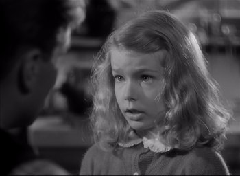 Movie still from “The Curse of the Cat People” (1944), directed by Robert Wise – A little girl with blonde hair is looking at the camera; Close Up shot, Over the shoulder angle