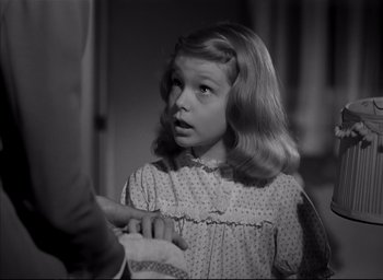 Movie still from “The Curse of the Cat People” (1944), directed by Robert Wise – A young girl in a polka dot dress looking surprised; Close Up shot, High angle