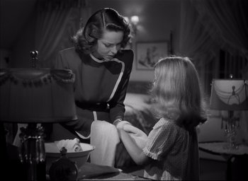 Movie still from “The Curse of the Cat People” (1944), directed by Robert Wise – A woman and a little girl sitting at a table; Medium shot, Over the shoulder angle