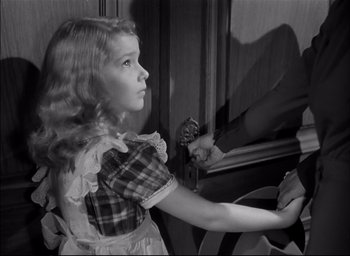 Movie still from “The Curse of the Cat People” (1944), directed by Robert Wise – A young girl in a dress looking out a window; Close Up shot, High angle