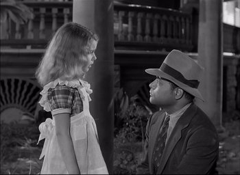 Movie still from “The Curse of the Cat People” (1944), directed by Robert Wise – A man and a little girl talking to each other; Medium shot, High angle