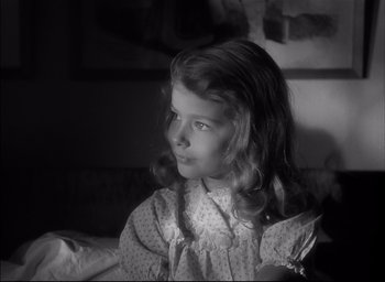 Movie still from “The Curse of the Cat People” (1944), directed by Robert Wise – A little girl sitting on a bed in a room; Close Up shot, High angle