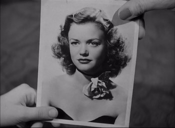 Movie still from “The Curse of the Cat People” (1944), directed by Robert Wise – An old black and white photo of a woman; Close Up shot, Over the shoulder angle