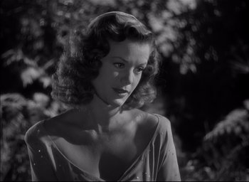 Movie still from “The Curse of the Cat People” (1944), directed by Robert Wise – A black - and - white photo of a woman in a dress; Close Up shot, Low angle