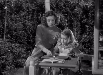 Movie still from “The Curse of the Cat People” (1944), directed by Robert Wise – A woman and a girl sitting at a table; Medium shot, High angle