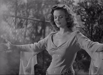 Movie still from “The Curse of the Cat People” (1944), directed by Robert Wise – A black - and - white photo of a woman dancing; Medium shot, Low angle