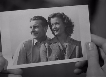 Movie still from “The Curse of the Cat People” (1944), directed by Robert Wise – An old photo of a man and a woman; Close Up shot, Low angle