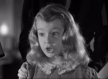 Movie still from “The Curse of the Cat People” (1944), directed by Robert Wise – A little girl with long blonde hair is looking at the camera; Close Up shot, High angle