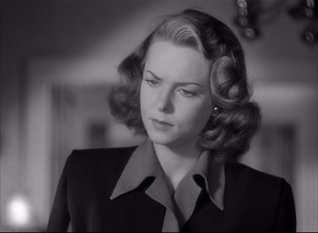 Movie still from “The Curse of the Cat People” (1944), directed by Robert Wise – An old photo of a woman in a black suit; Close Up shot, Low angle