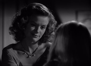 Movie still from “The Curse of the Cat People” (1944), directed by Robert Wise – A black - and - white photo of a woman talking to another woman; Close Up shot, Over the shoulder angle