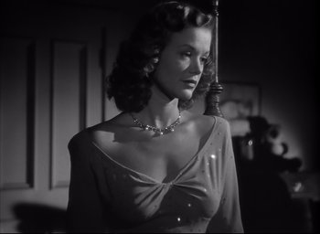 Movie still from “The Curse of the Cat People” (1944), directed by Robert Wise – A black and white photo of a woman in a dress; Medium shot, Low angle