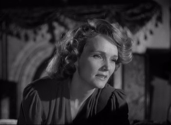 Movie still from “The Curse of the Cat People” (1944), directed by Robert Wise – An old photo of an older woman with long blonde hair; Close Up shot, Low angle