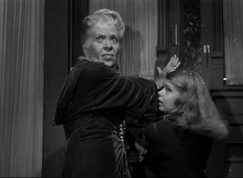 Movie still from “The Curse of the Cat People” (1944), directed by Robert Wise – An older woman getting her hair done by a younger woman; Medium shot, Low angle