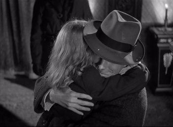 Movie still from “The Curse of the Cat People” (1944), directed by Robert Wise – A man and a woman hugging each other in a black and white photo; Close Up shot, High angle