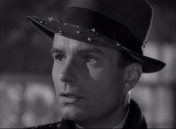Movie still from “The Curse of the Cat People” (1944), directed by Robert Wise – A black and white photo of a man wearing a hat; Close Up shot, Low angle