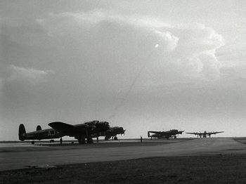 Movie still from “The Dam Busters” (1955), directed by Michael Anderson – A black and white photo of airplanes on a runway; Extreme Wide shot, Low angle