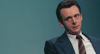 Movie still from “The Damned United” (2009), directed by Tom Hooper – A person wearing a suit and tie; Close Up shot, Over the shoulder angle