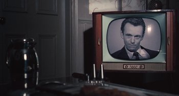 Movie still from “The Damned United” (2009), directed by Tom Hooper – An old tv with a picture of a man on the screen; Extreme Close Up shot, Over the shoulder angle