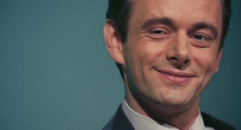 Movie still from “The Damned United” (2009), directed by Tom Hooper – A man smiling for the camera; Close Up shot, Low angle