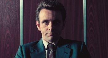 Movie still from “The Damned United” (2009), directed by Tom Hooper – A person wearing a suit and tie; Close Up shot, Low angle