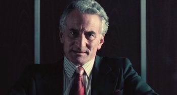 Movie still from “The Damned United” (2009), directed by Tom Hooper – An older man wearing a suit and tie; Close Up shot, Low angle
