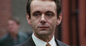 Movie still from “The Damned United” (2009), directed by Tom Hooper – A person wearing a suit and tie; Close Up shot, Low angle