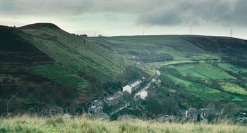 Movie still from “The Damned United” (2009), directed by Tom Hooper – A view of a small town on a hillside; Extreme Wide shot, High angle