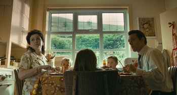 Movie still from “The Damned United” (2009), directed by Tom Hooper – A group of people sitting around a table eating; Medium shot, Low angle