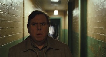 Movie still from “The Damned United” (2009), directed by Tom Hooper – A man standing in a hallway with his mouth wide open; Close Up shot, Over the shoulder angle