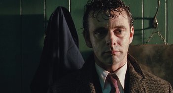 Movie still from “The Damned United” (2009), directed by Tom Hooper – A person wearing a suit and tie; Close Up shot, Low angle