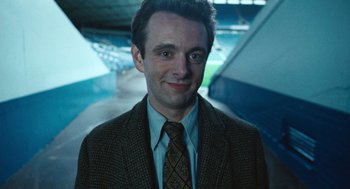 Movie still from “The Damned United” (2009), directed by Tom Hooper – A person wearing a suit and tie; Close Up shot, High angle