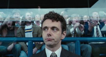 Movie still from “The Damned United” (2009), directed by Tom Hooper – A person wearing a suit and tie; Close Up shot, Over the shoulder angle