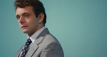Movie still from “The Damned United” (2009), directed by Tom Hooper – A person wearing a suit and tie; Close Up shot, Low angle