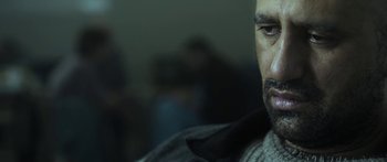 Movie still from “The Dark Horse” (2014), directed by James Napier Robertson – A man's face in a dark room; Close Up shot, Over the shoulder angle