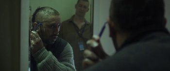 Movie still from “The Dark Horse” (2014), directed by James Napier Robertson – A man with a beard is looking in the mirror; Close Up shot, Over the shoulder angle