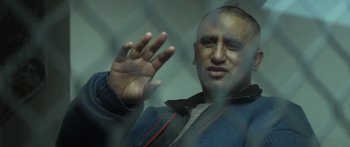 Movie still from “The Dark Horse” (2014), directed by James Napier Robertson – A man in a blue jacket is looking out of a window; Close Up shot, Over the shoulder angle