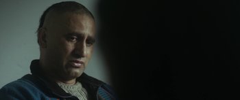 Movie still from “The Dark Horse” (2014), directed by James Napier Robertson – A person wearing a jacket; Close Up shot, Over the shoulder angle