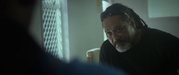 Movie still from “The Dark Horse” (2014), directed by James Napier Robertson – A person wearing a black shirt; Close Up shot, Over the shoulder angle