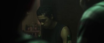 Movie still from “The Dark Horse” (2014), directed by James Napier Robertson – A man sitting at a table in a dark room; Close Up shot, Over the shoulder angle